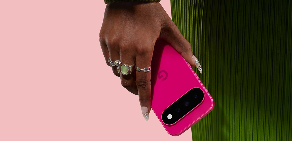 en kvinne med grønn kjole holder den nye mobilen pixel 11 i fargen hibiscus