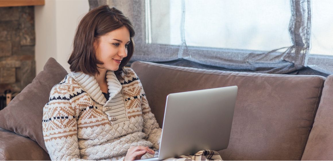 Strøm på hytta: kvinne surfer på laptop på hytta