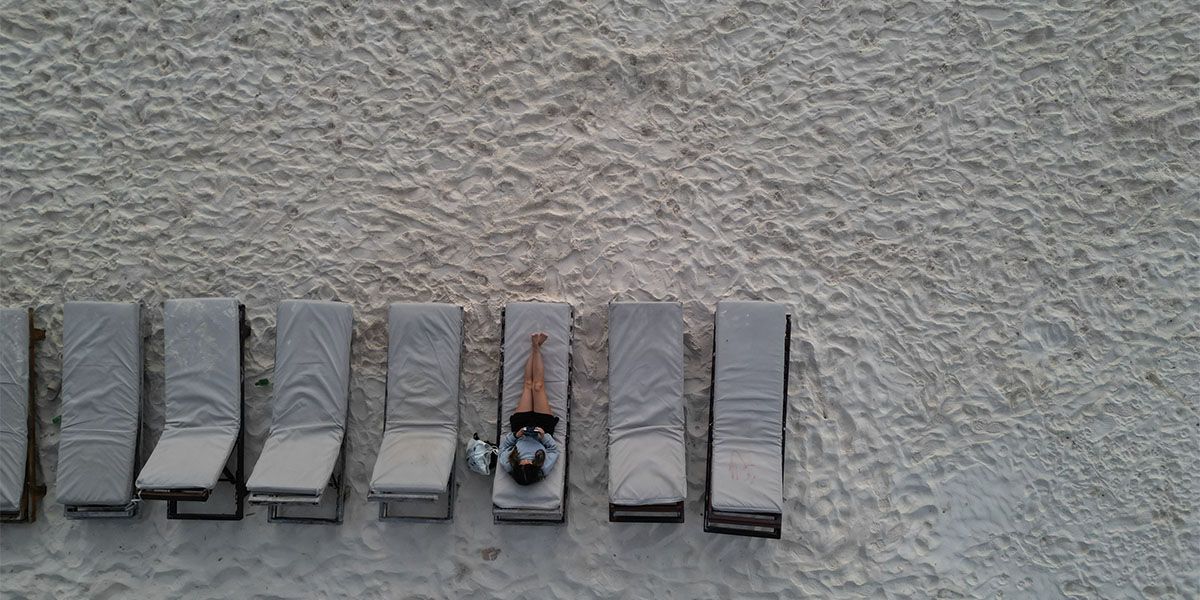 Kvinne som ligger på en strandstol